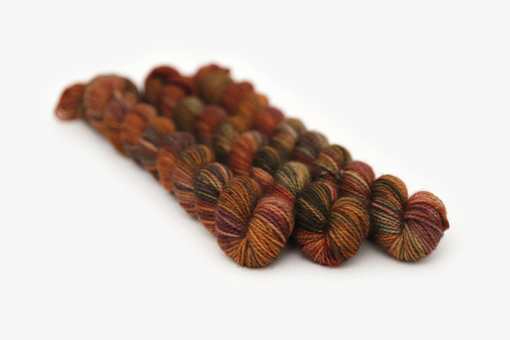 speckled hand dyed rust red green orange merino sock mini yarn