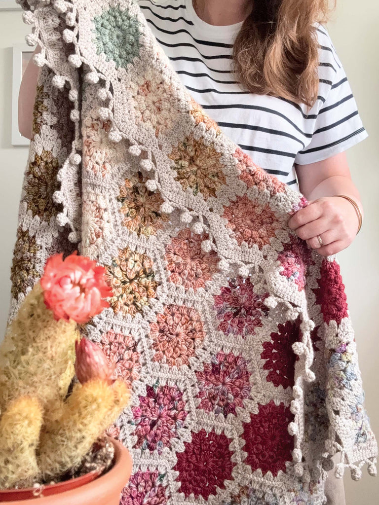 A blanket crocheted in Desert Bloom Collection yarn