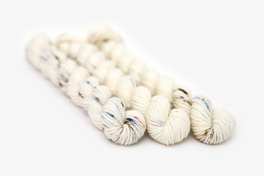 speckled hand dyed white olive yellow blue dk mini yarn