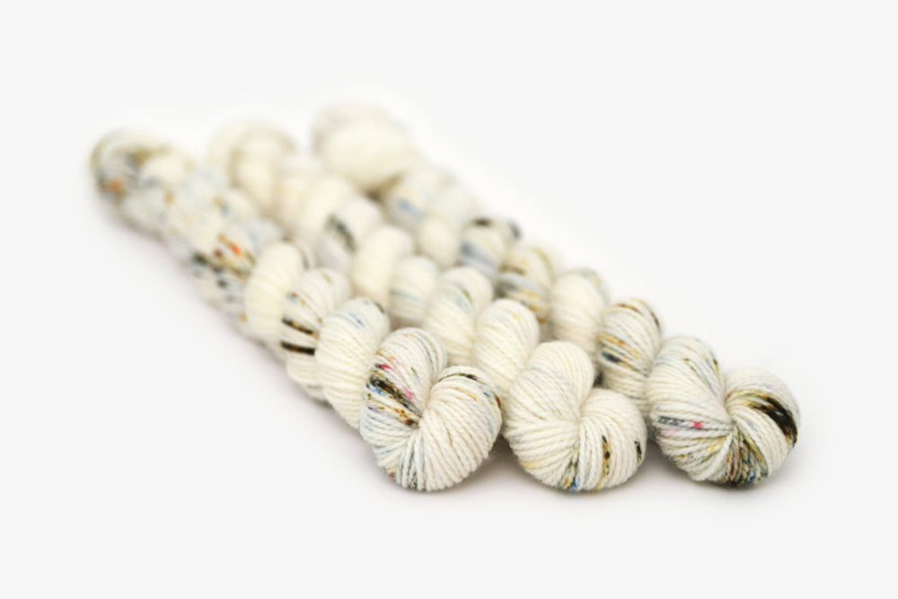 speckled hand dyed white olive yellow blue merino sock mini yarn