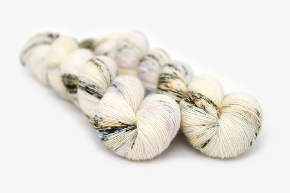 speckled hand dyed white olive yellow blue single sock yarn
