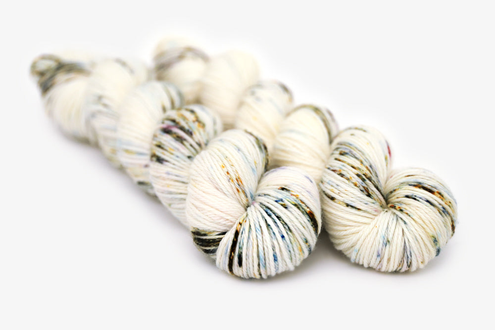 speckled hand dyed white olive yellow blue worsted yarn
