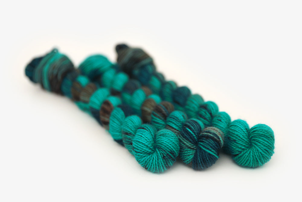 speckled hand dyed teal aqua dark purple merino sock mini yarn