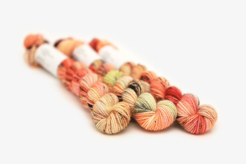speckled hand dyed bright orange coral pink merino sock mini yarn