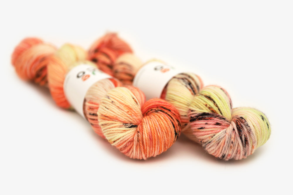 speckled hand dyed bright orange coral pink worsted yarn