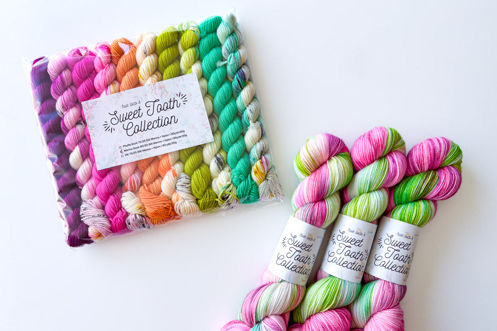 speckled semisolid hand dyed purple fuchsia orange white green cyan yarn and set