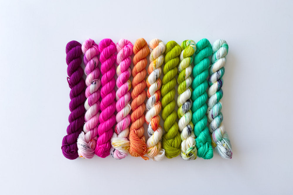 speckled semisolid hand dyed purple fuchsia orange white green cyan yarn set