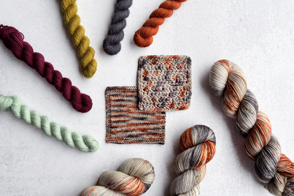 speckled hand dyed  green orange red gray yarn swatches