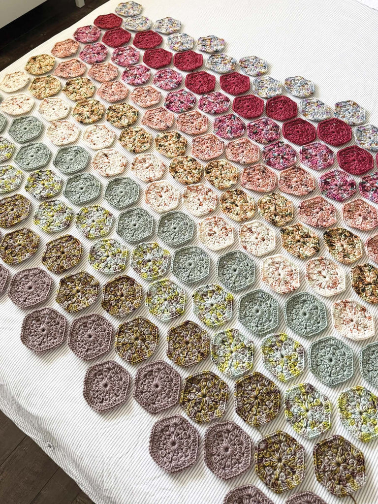 blanket hexagons being crocheted out of semisolid speckled hand dyed desert colors of yarn