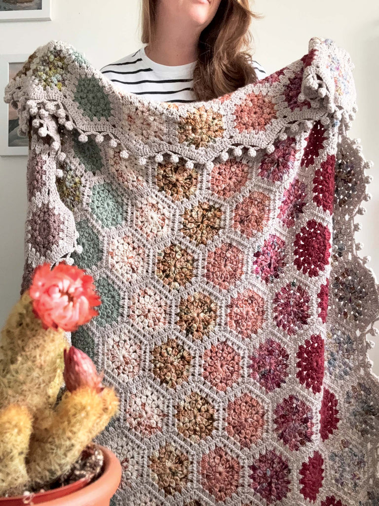 blanket made out of semisolid speckled hand dyed desert colors of dk yarn