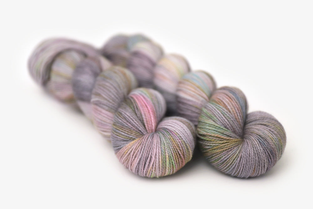 tonal hand dyed gray plum peach green blue merino sock yarn