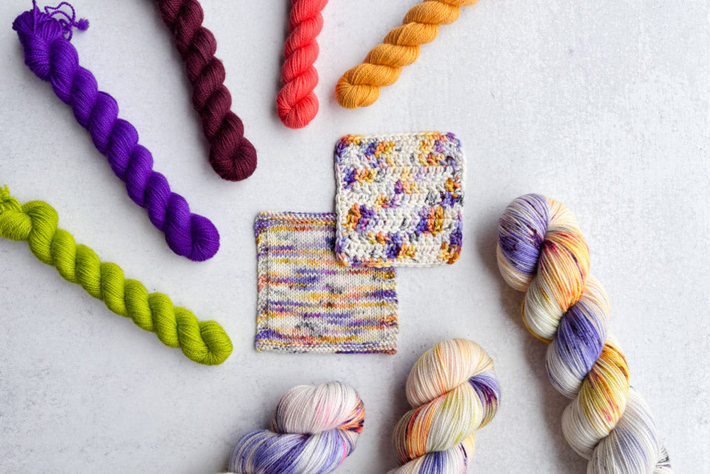 speckled hand dyed white orange pink purple teal green yarn swatches