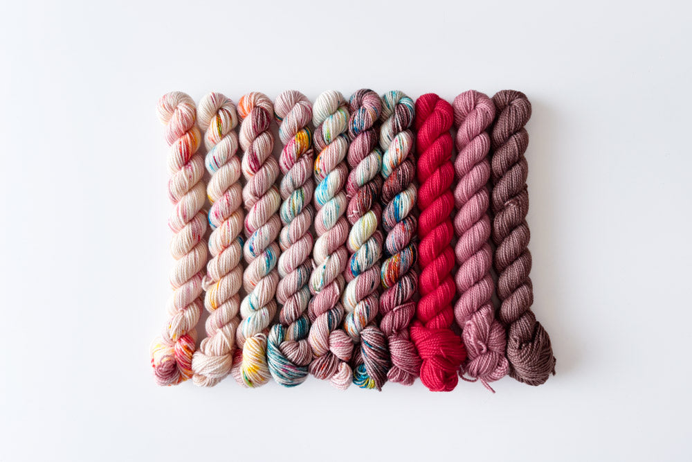 speckled semisolid hand dyed peach aqua fuchsia brown purple yarn set