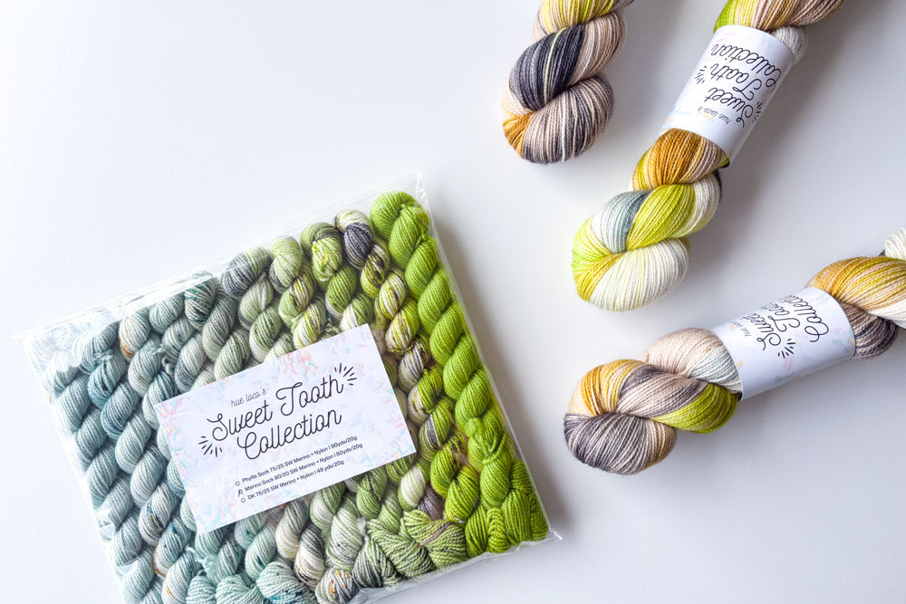 speckled semisolid hand dyed light blue lime green gray yarn and set