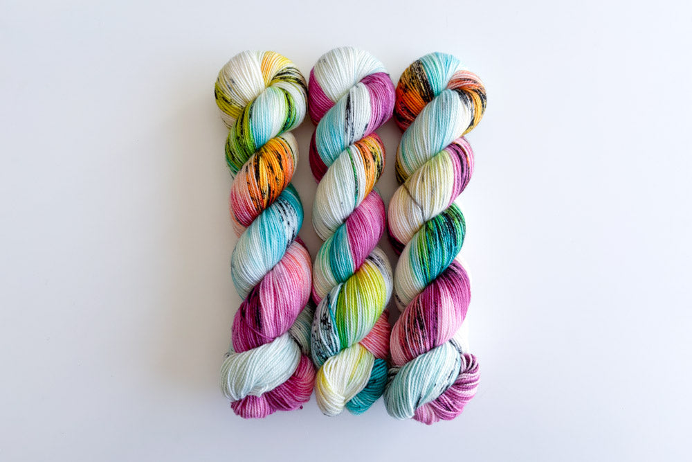 speckled hand dyed white magenta turquoise blue orange green yarn