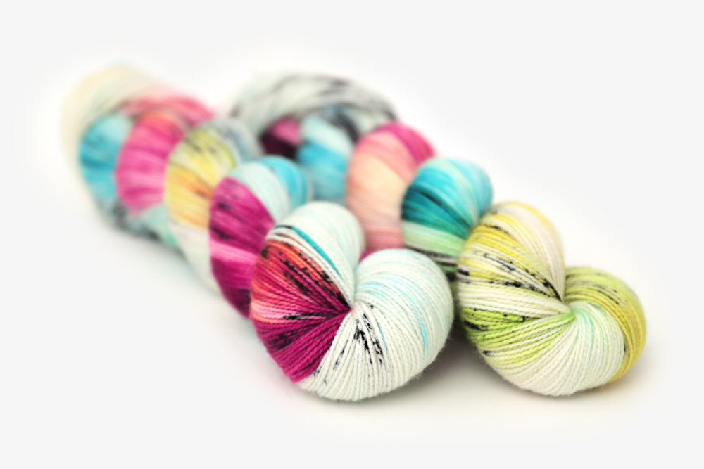 speckled hand dyed white magenta turquoise blue orange green yarn