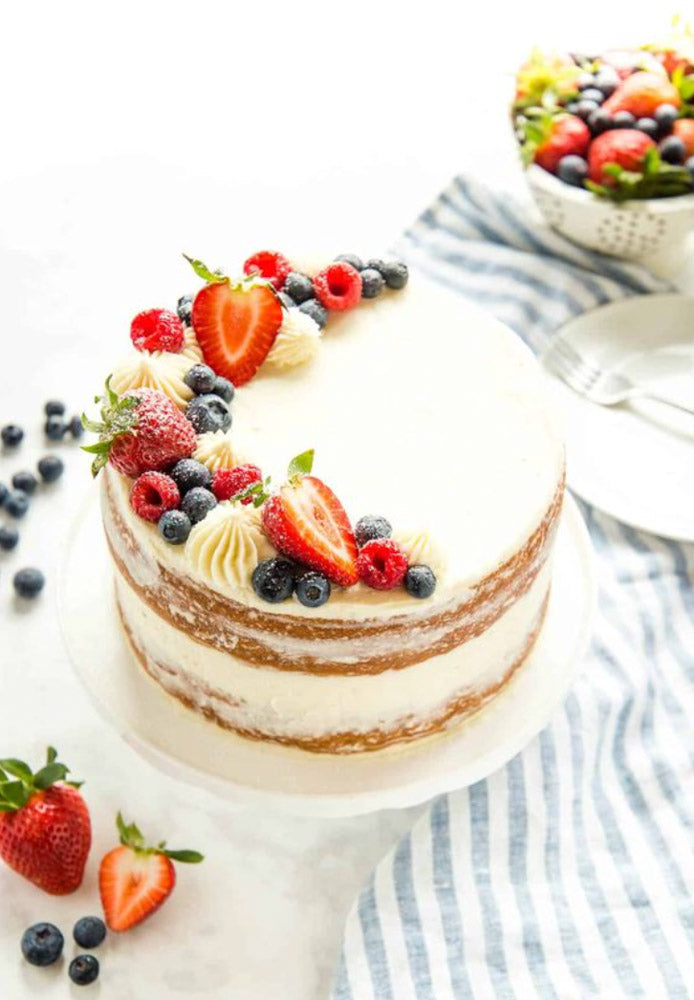 white chantilly cake with strawberries blueberries and raspberries