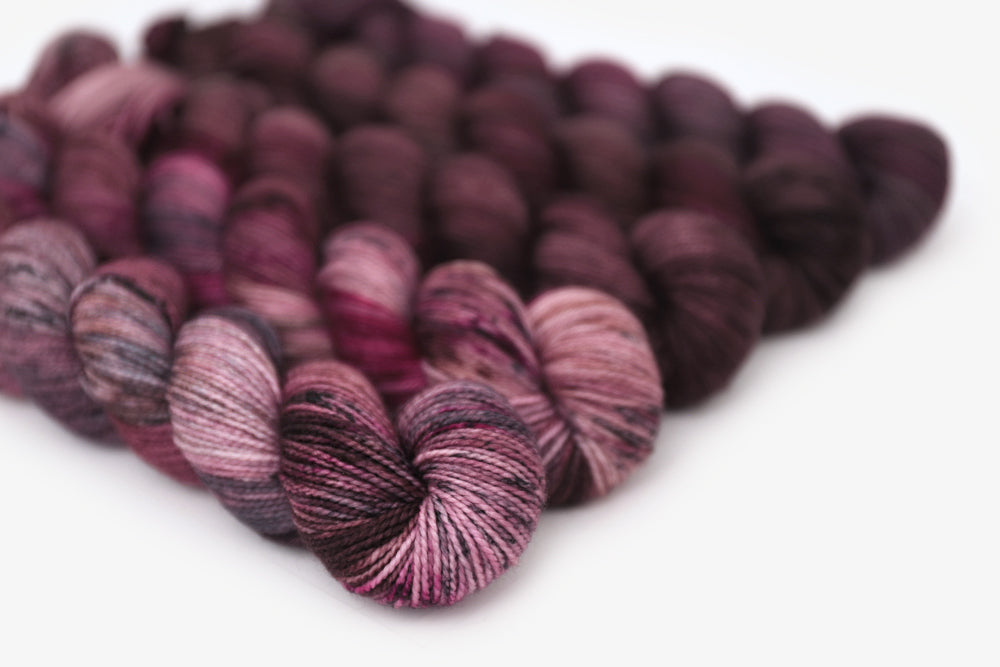 speckled hand dyed white pink dark mauve maroon brown yarn 50s set