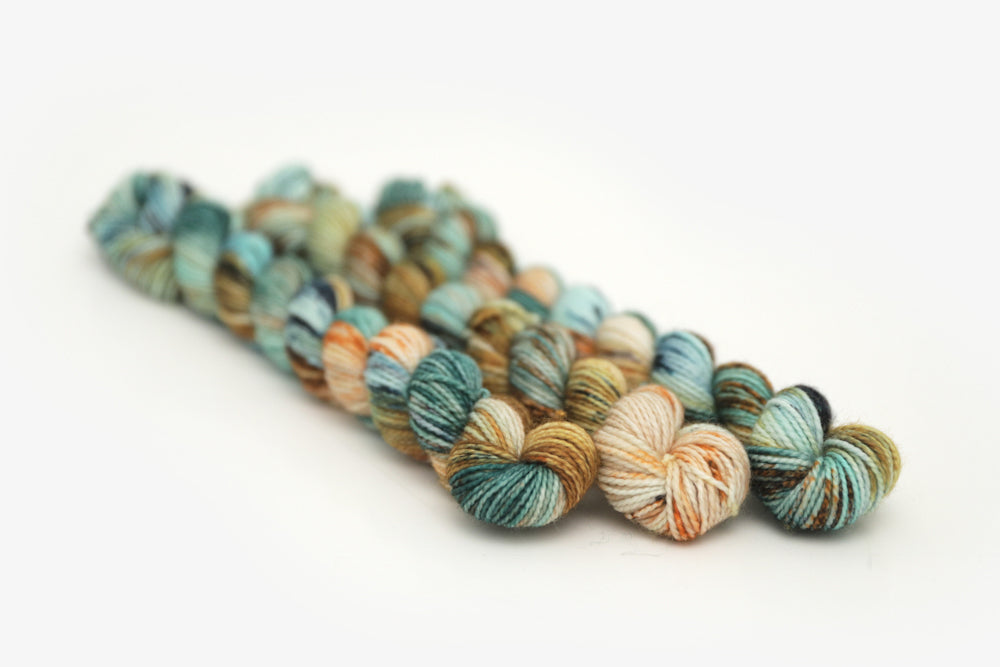 speckled hand dyed bright teal emerald tan orange merino sock mini yarn