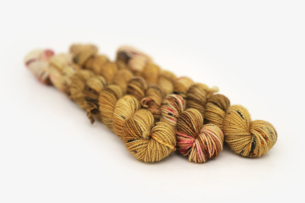 speckled hand dyed gold ochre fuchsia merino sock mini yarn