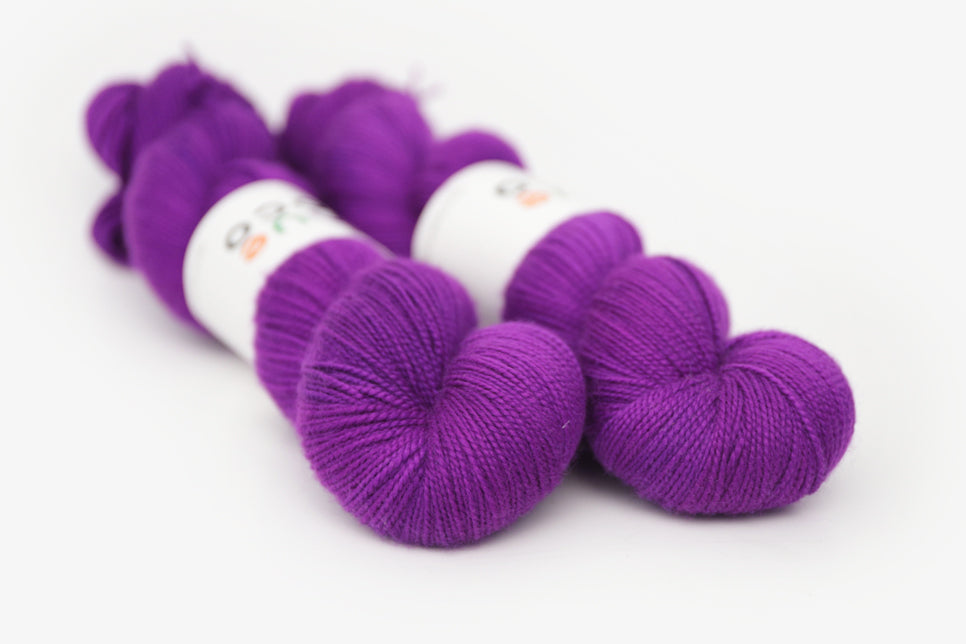 semisolid hand dyed bright pink purple merino sock yarn