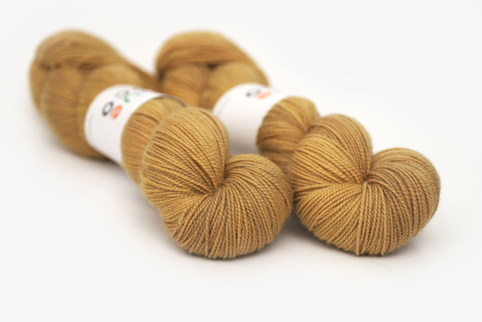 semisolid hand dyed ochre (dark bronze yellow) merino sock yarn