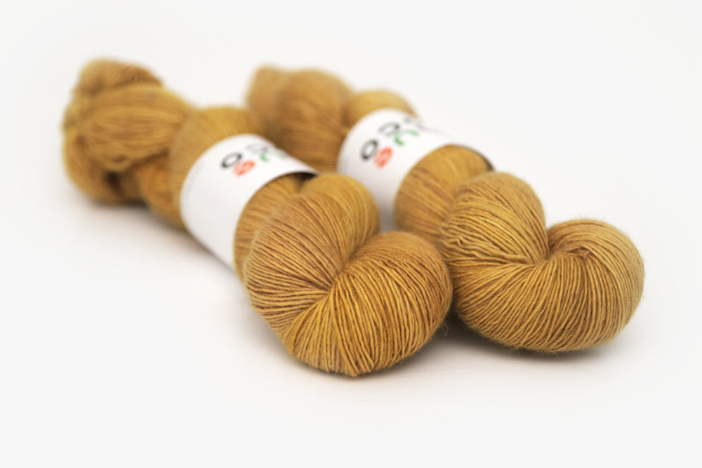 semisolid hand dyed ochre (dark bronze yellow) single sock yarn