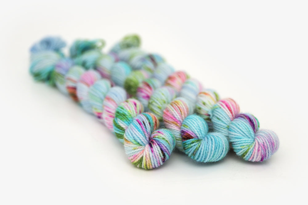 speckled hand dyed bright aqua green purple merino sock mini yarn