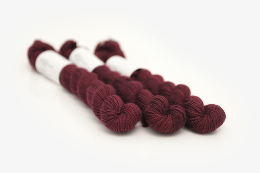 semisolid hand dyed sangria (dark wine burgundy red) phyllis sock mini yarn