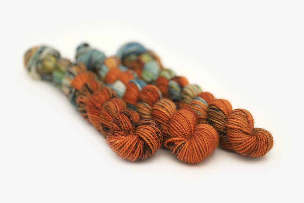 speckled hand dyed burnt orange teal green merino sock mini yarn